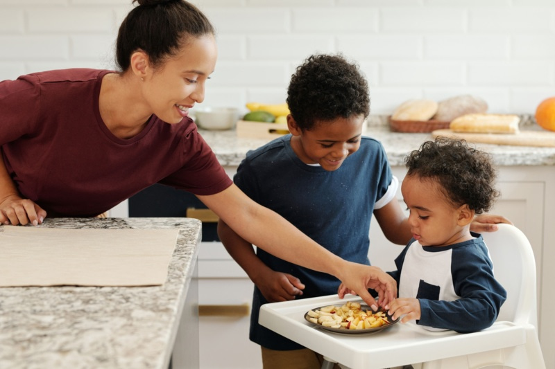 Bébé partageant un repas en famille dans sa chaise haute