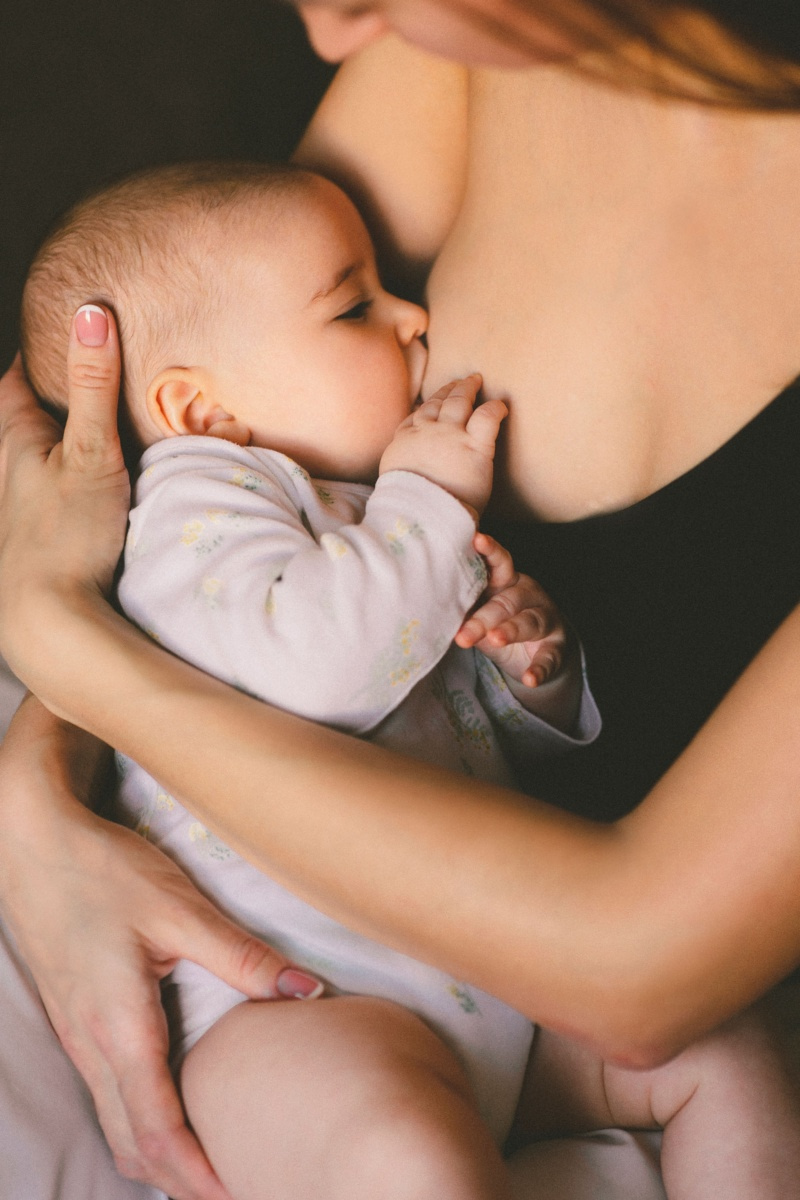 Bébé allaité au sein dans les bras de sa maman
